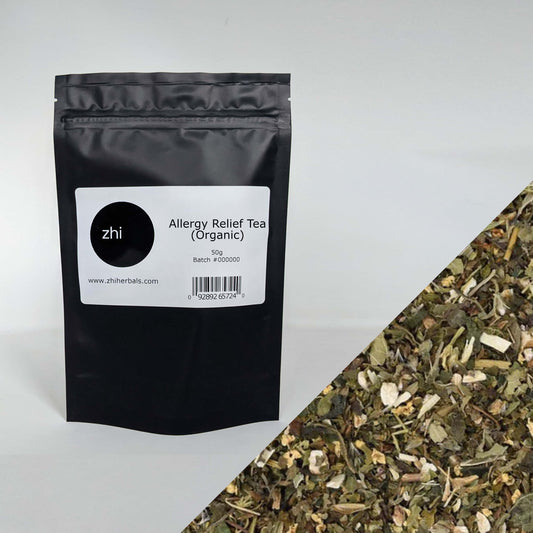 Zhi Herbals Organic Allergy Relief Tea, 50g black package with label, next to a close-up of the green tea blend.