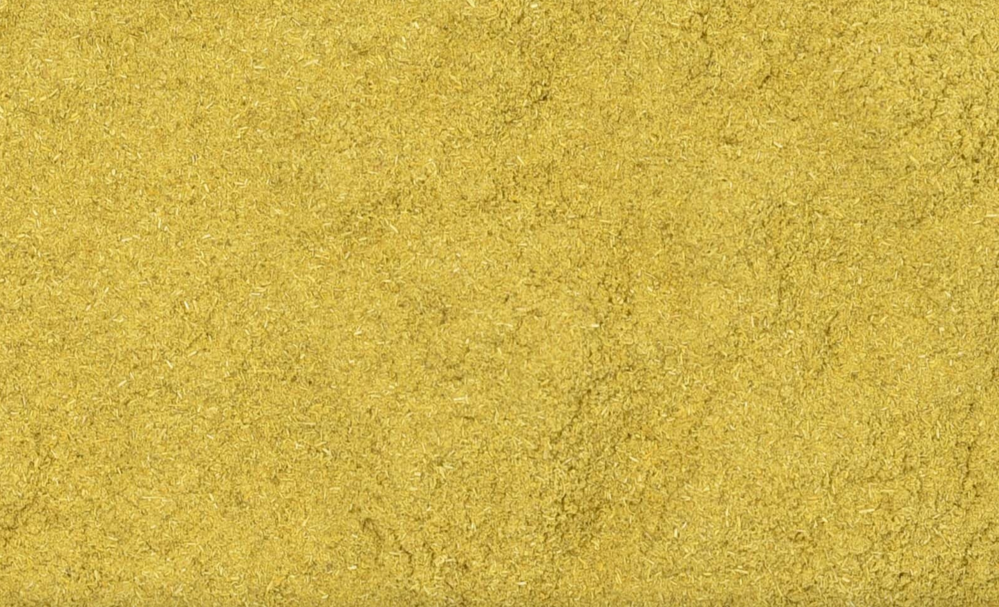 Close-up texture of dried barberry root powder, showing fine yellow powder used for teas and herbal remedies.