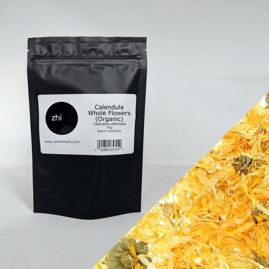 Zhi Herbals Organic Calendula Whole Flowers, 50g black package with label, next to a close-up of the vibrant yellow flowers.