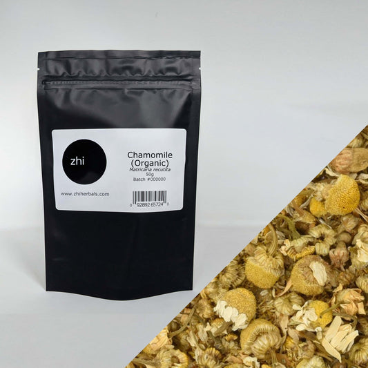 Zhi Herbals Organic Chamomile, 50g black package with label, next to a close-up of the yellow flowers.