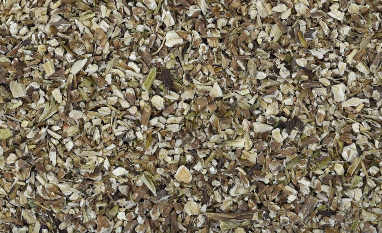 Close-up texture of dried dandelion root, showing fine brown root pieces used for teas and herbal remedies.