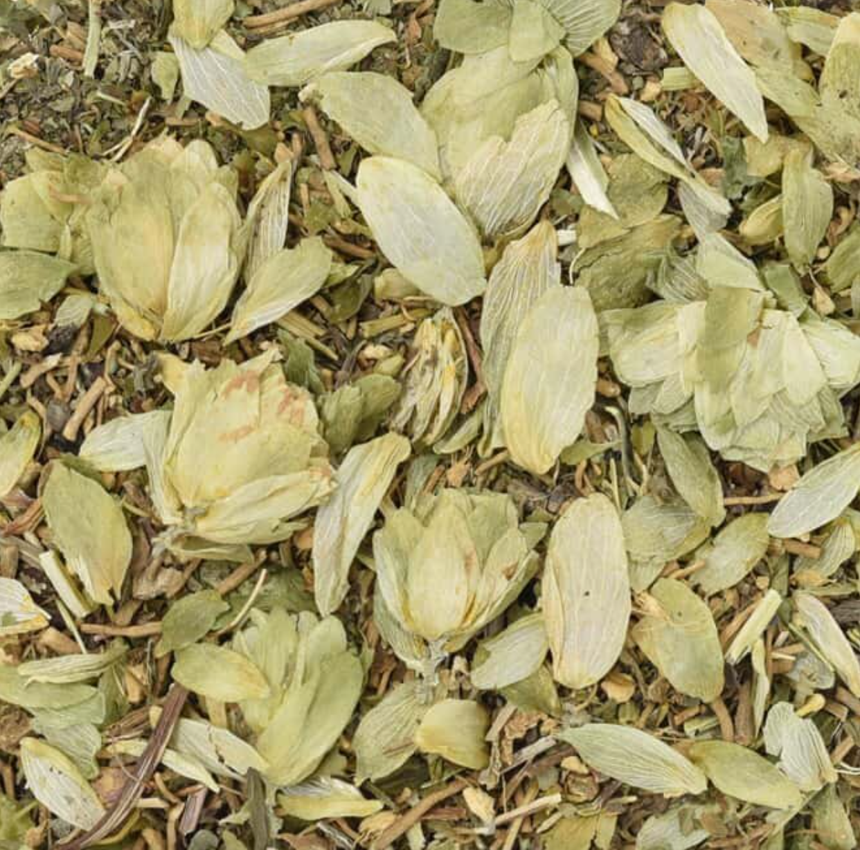 Close-up of dried Deep Sleep Tea, showing chopped flowers, leaves, and herb pieces.