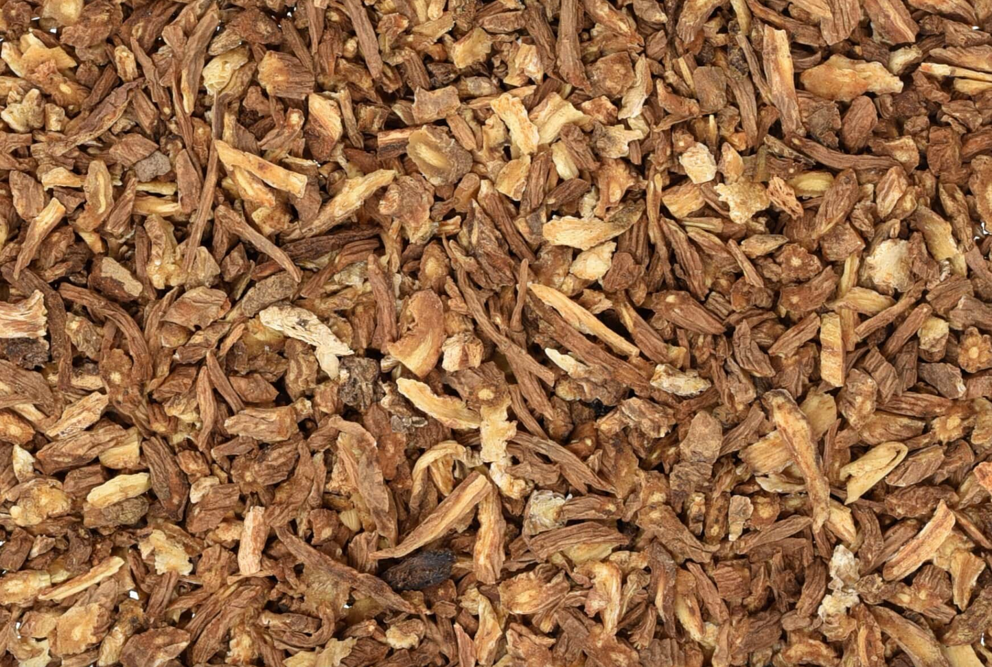 Close-up of dried dong quai root, showing small brown root pieces used for teas and herbal remedies.