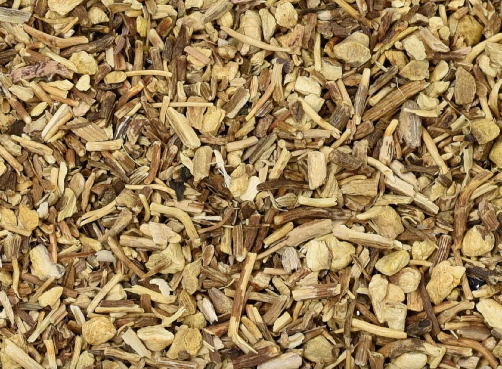 Close-up of dried gravel root, showing brown chopped root pieces used for teas and herbal remedies.