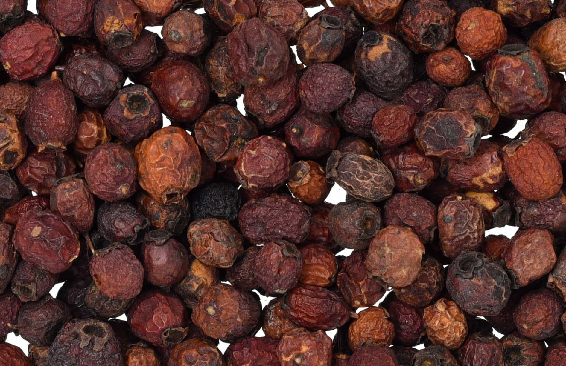 Close-up of dried hawthorn berries, showing dark red berries used for teas and herbal remedies.