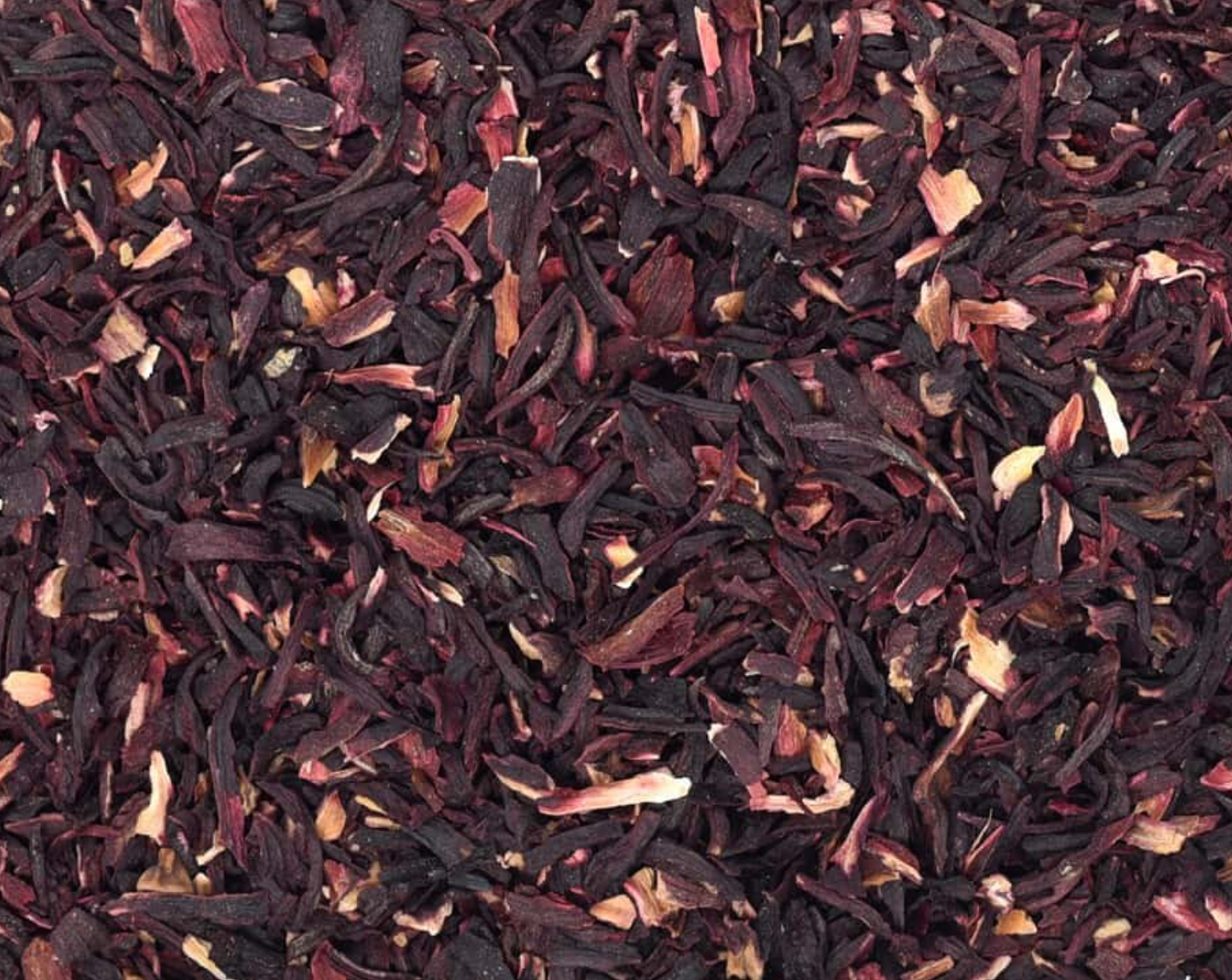 Close-up of dried hibiscus petals, showing small dark red petals used for teas and herbal remedies.