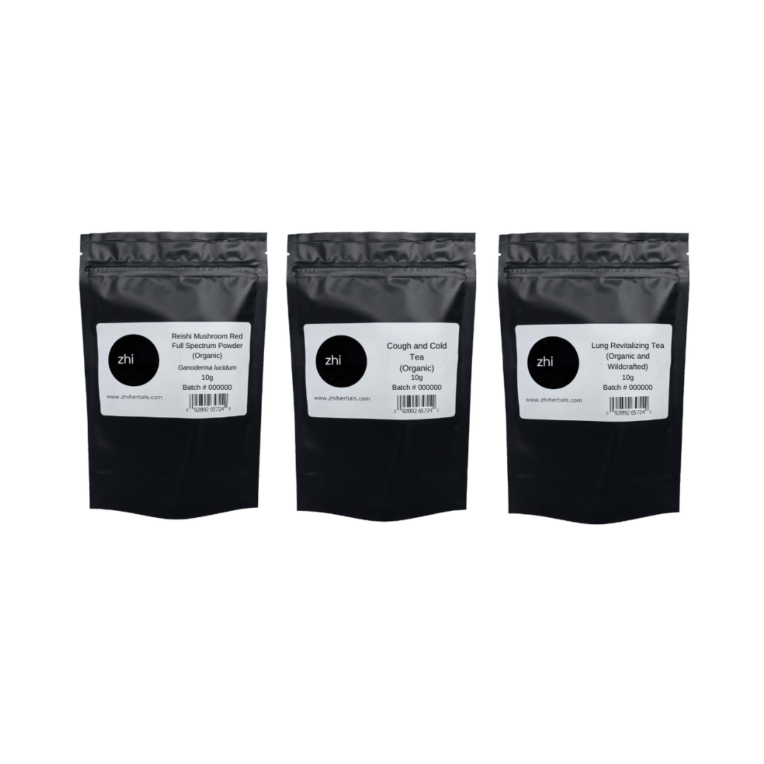 A row of three Zhi Herbals teas in black resealable bags with product labels and barcodes.