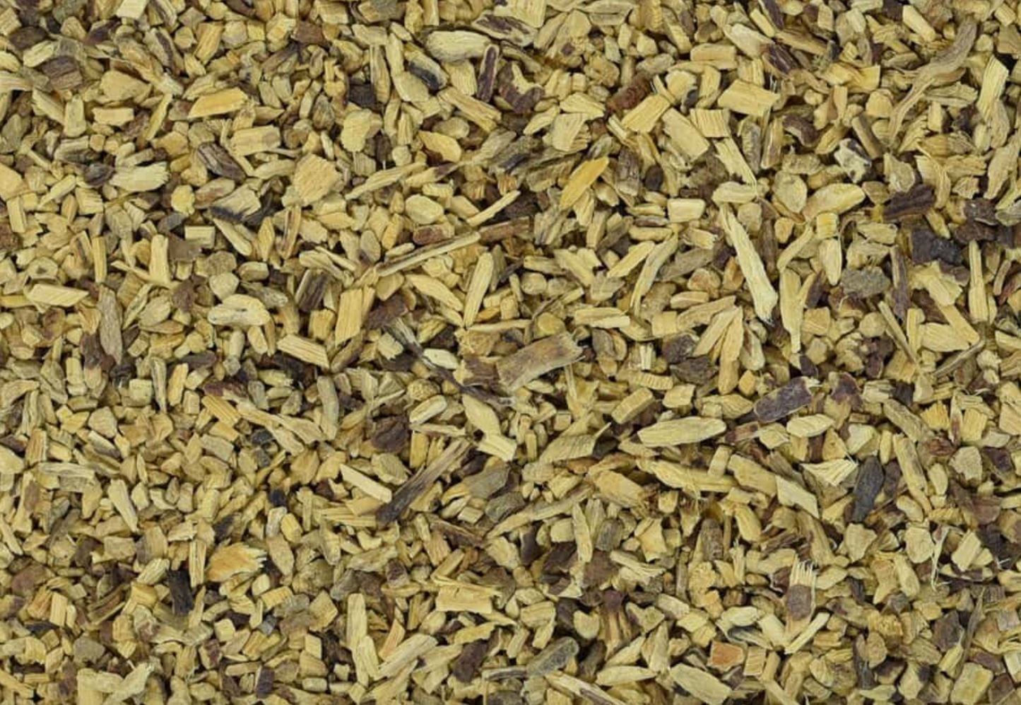 Close-up of dried licorice root, showing finely chopped brown root pieces used for teas and herbal remedies.