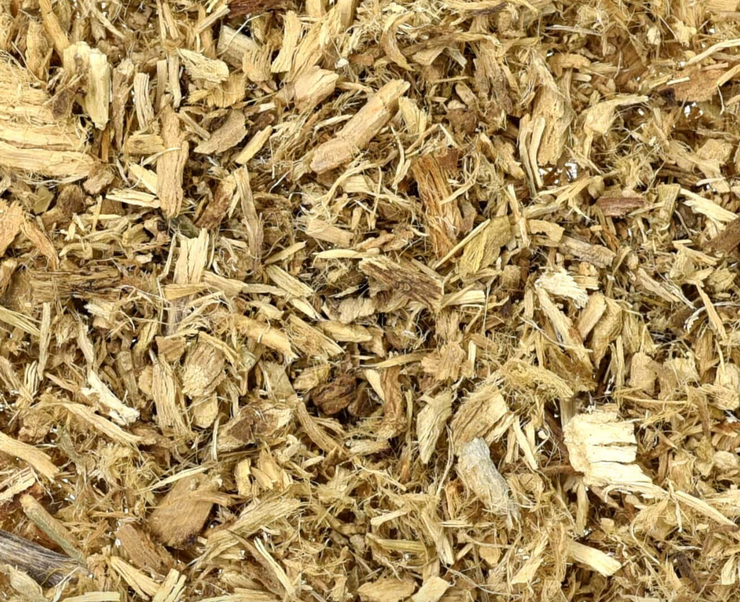 Close-up of dried marshmallow root, showing chopped off-white root pieces used for teas and herbal remedies.