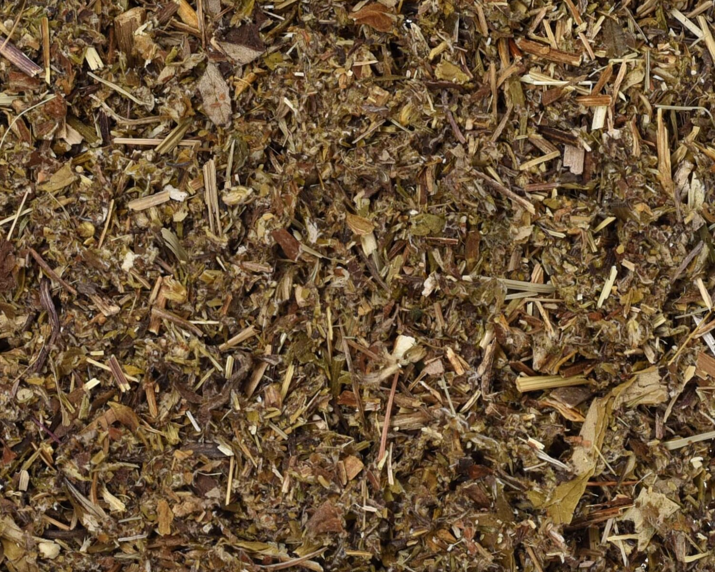 Close-up of dried mugwort herb, showing chopped stems, leaves, and pieces used for teas and herbal remedies.