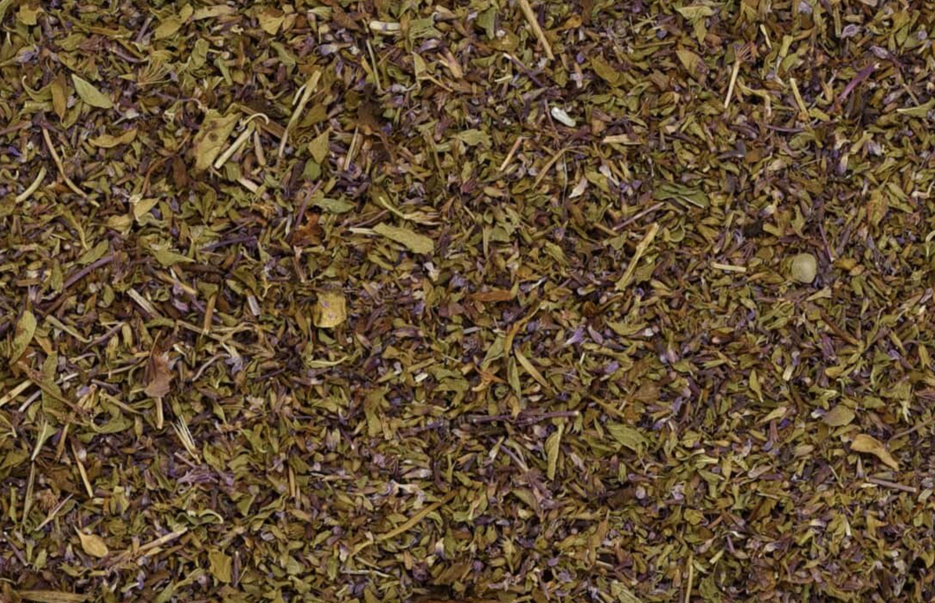 Close-up of dried pennyroyal herb, showing chopped leaves and flower used for teas and herbal remedies.