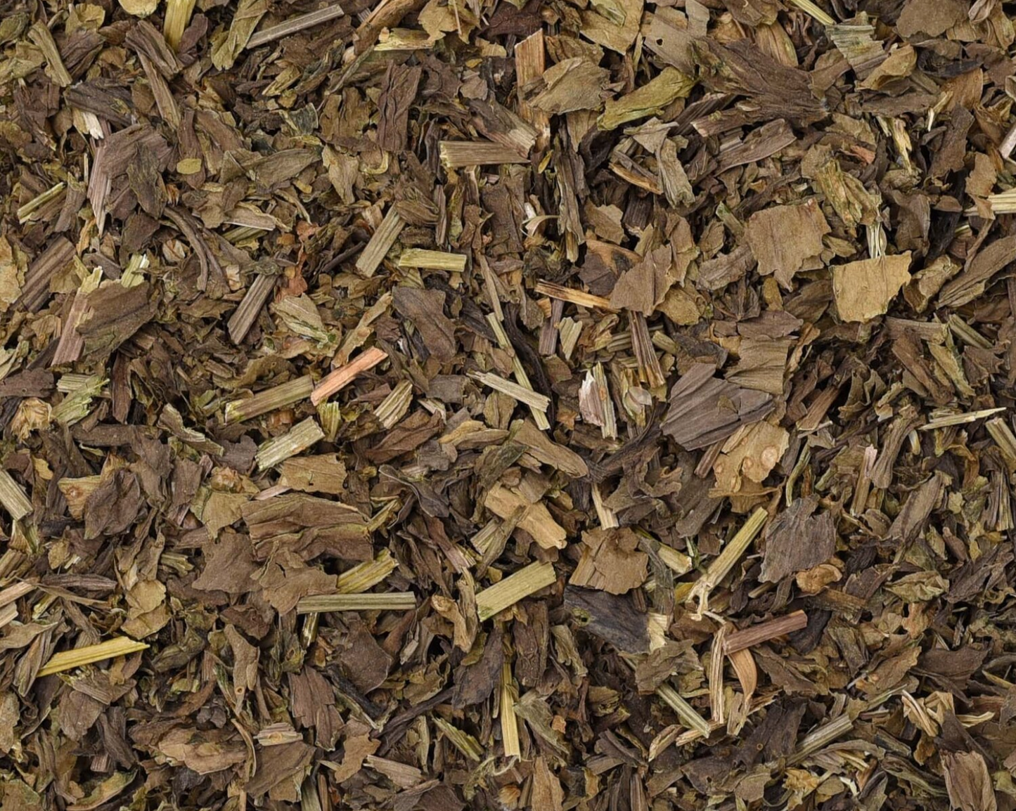 Close-up of dried plantain herb, showing chopped stems, leaves, and pieces used for teas and herbal remedies.