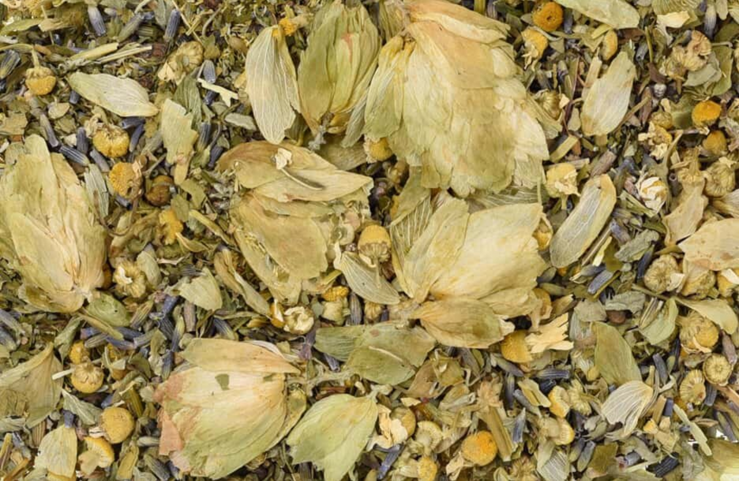 Close-up of dried Relaxing Tea, showing chopped flowers, leaves, and pieces used for teas and herbal remedies.