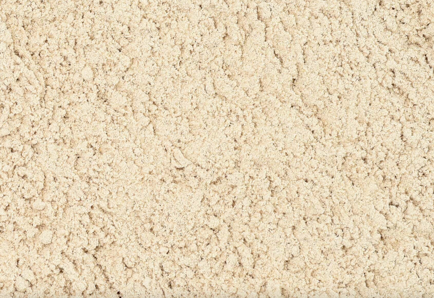 Close-up of dried slippery elm bark powder, showing beige powder used for teas and herbal remedies.