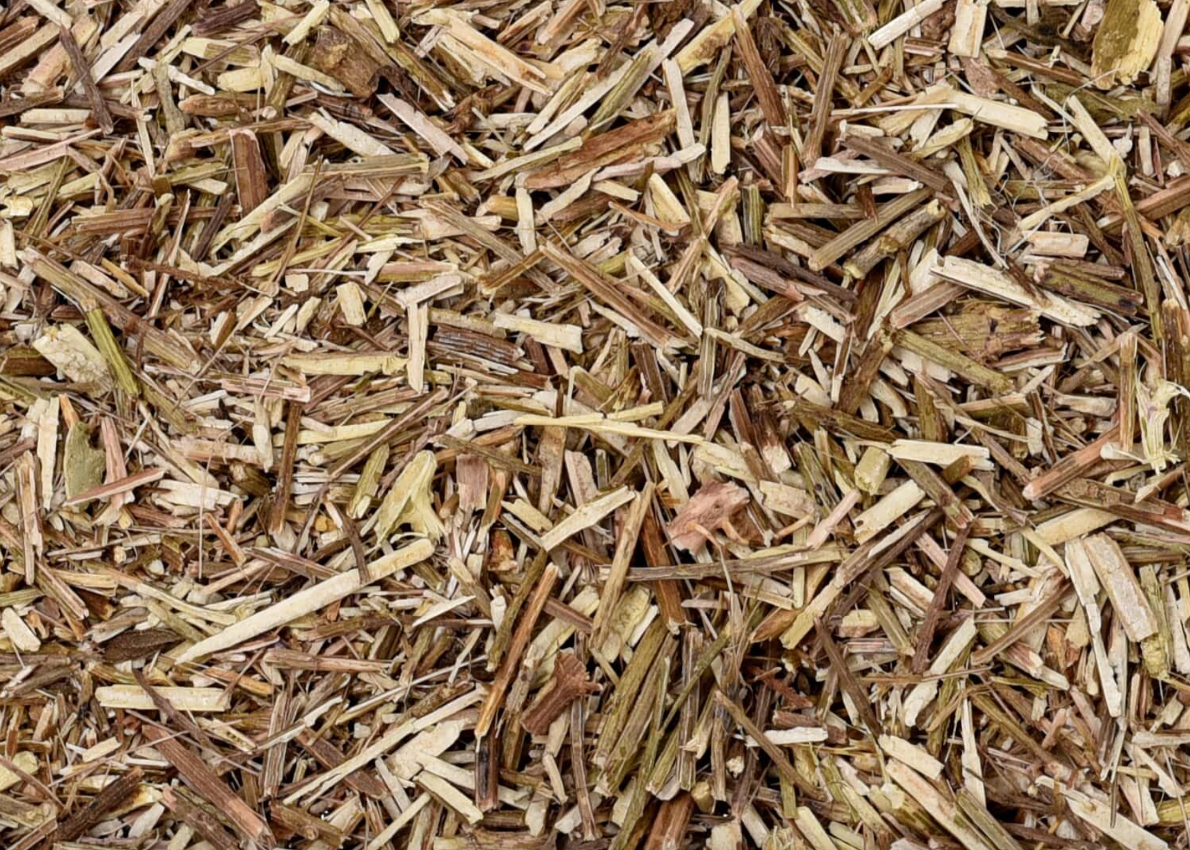 Close-up of dried vervain herb, showing chopped stems, leaves, and pieces used for teas and herbal remedies.