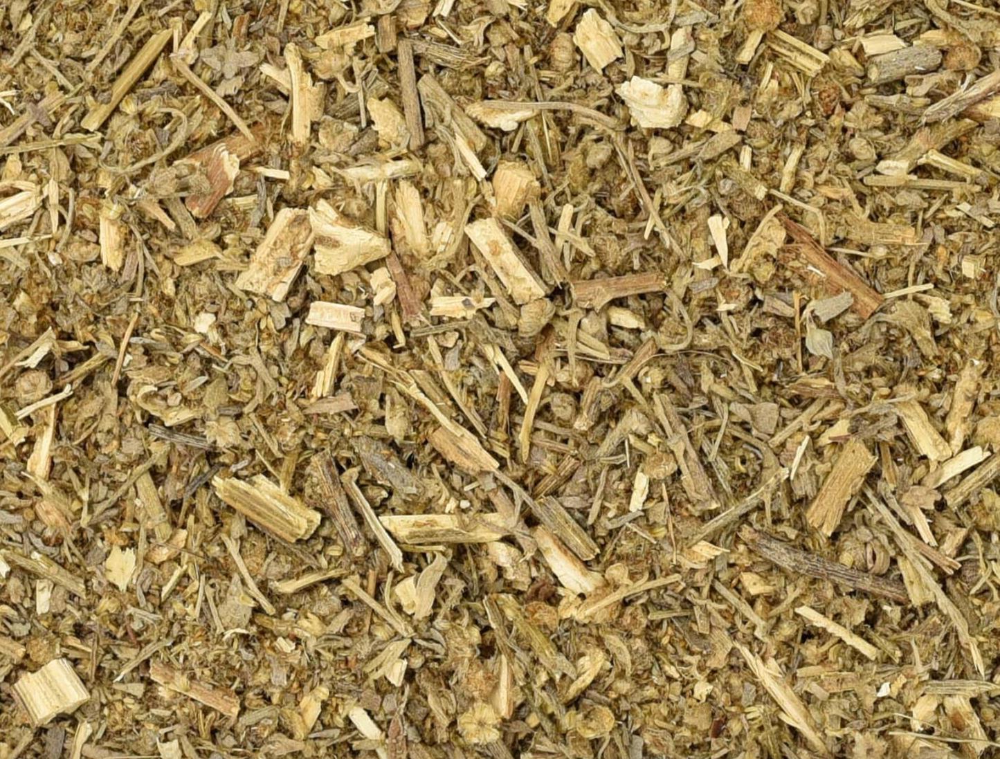 Close-up of dried wormwood herb, showing chopped stems, leaves, and pieces used for teas and herbal remedies.